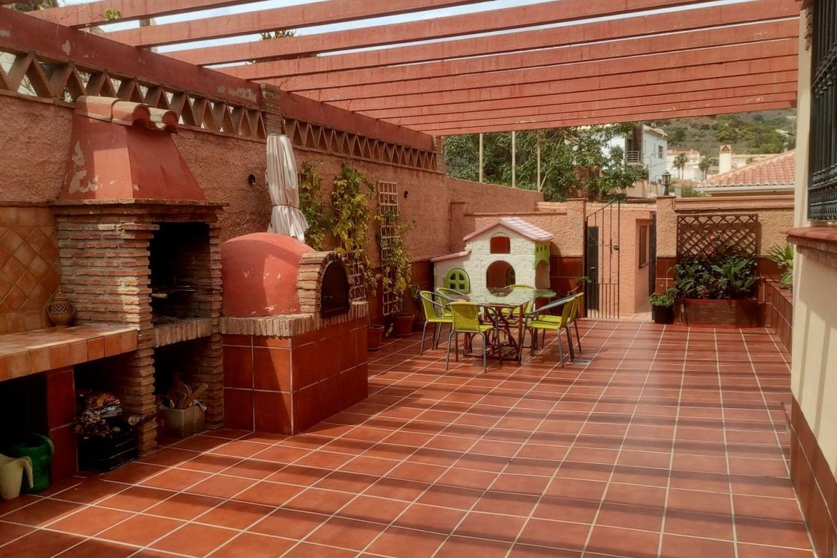Porche con barbacoa y zona de juegos en una de las villas